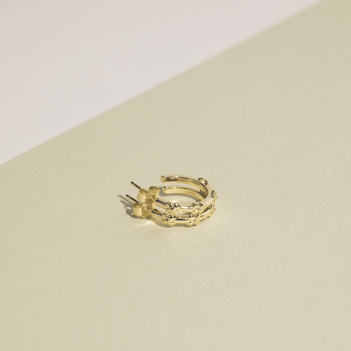 The hydrangea hoops are simple golden hoops adorned with hydrangea flowers.