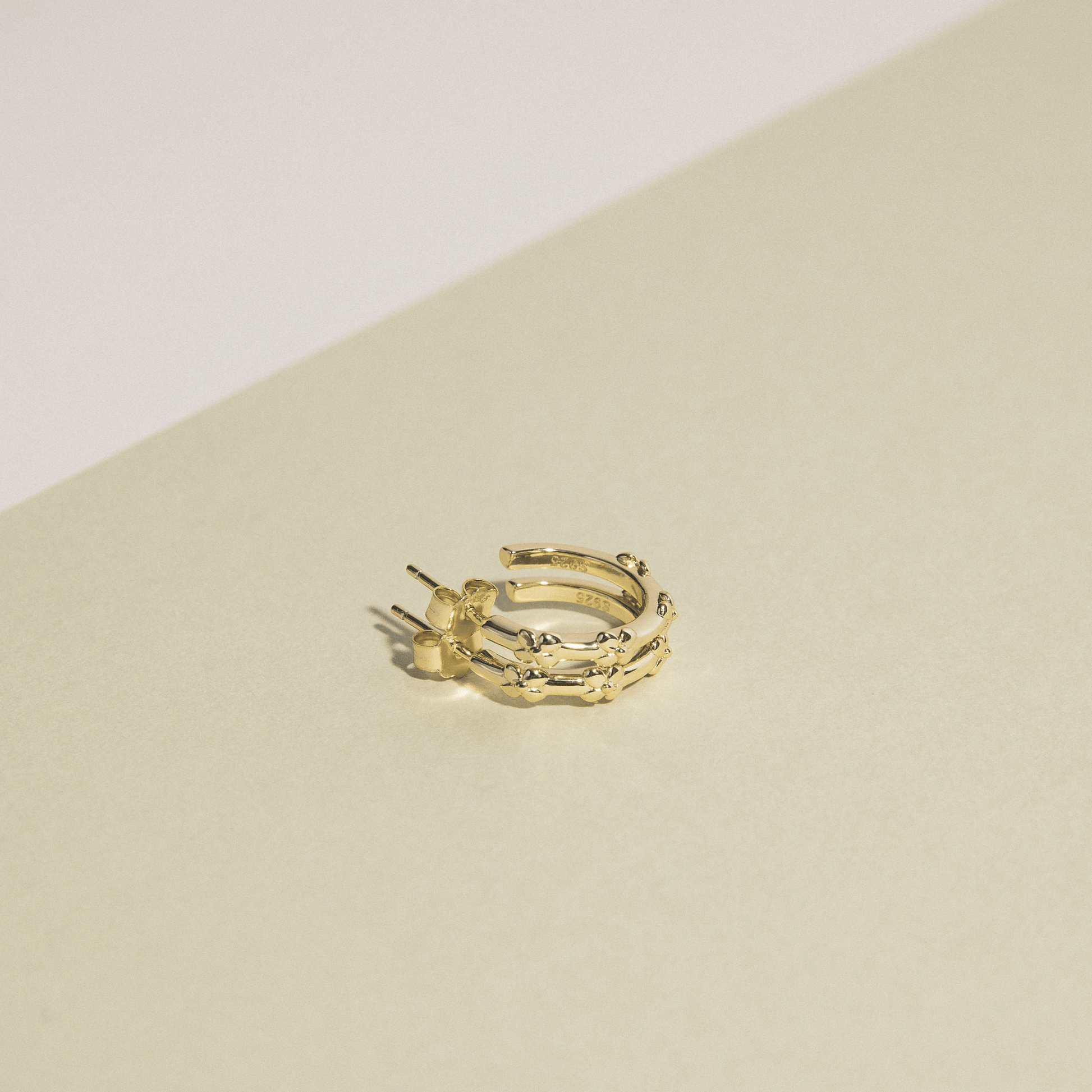 The hydrangea hoops are simple golden hoops adorned with hydrangea flowers.