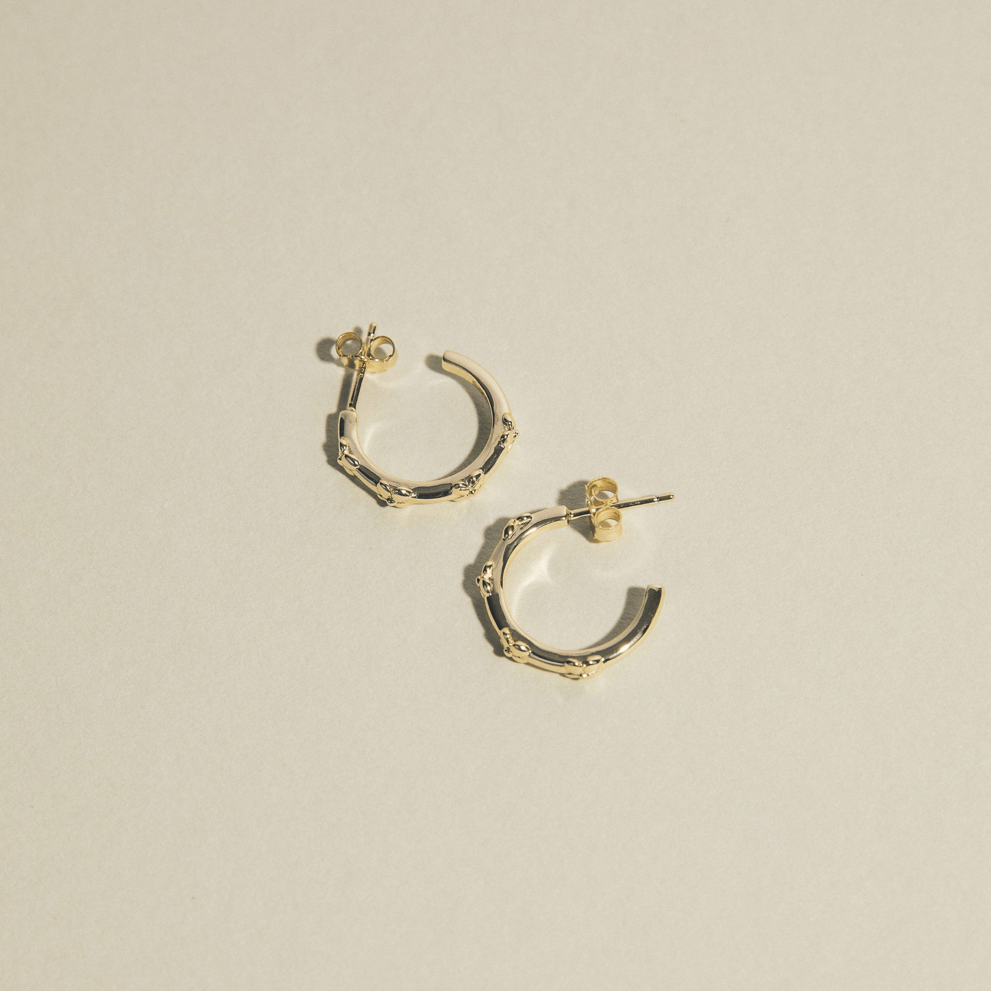 The hydrangea hoops are simple golden hoops adorned with hydrangea flowers.
