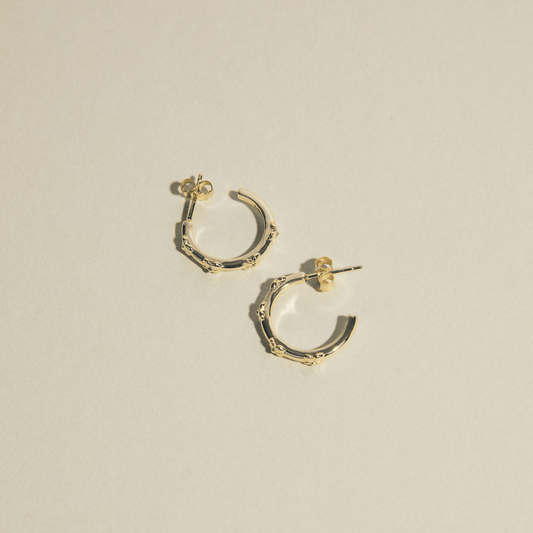 The hydrangea hoops are simple golden hoops adorned with hydrangea flowers.