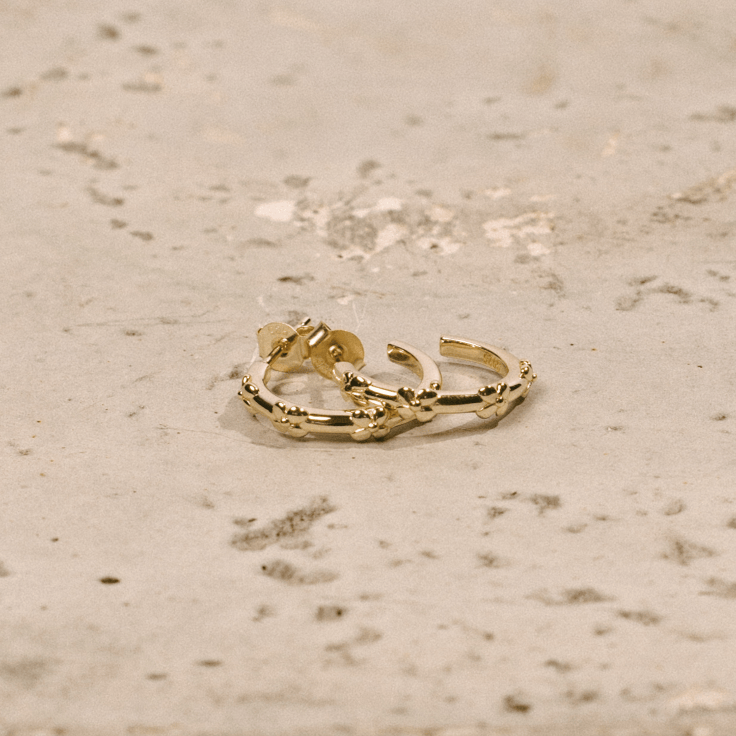 The hydrangea hoops are simple golden hoops adorned with hydrangea flowers.