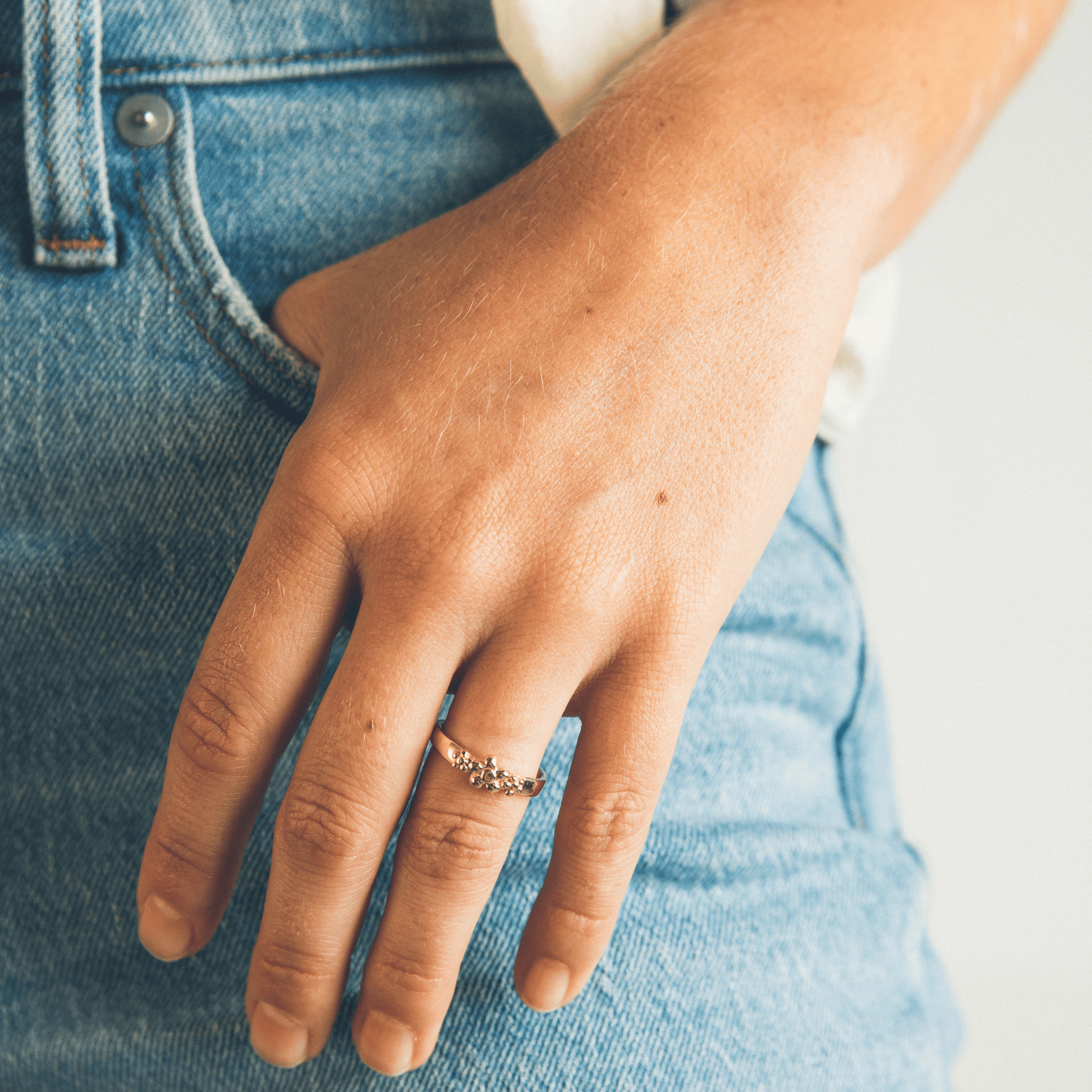 The Frida ring on a woman with a hand in her pocket.
