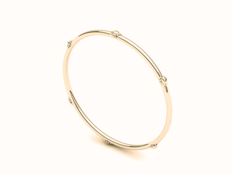 The sunflower bangle is a thin golden bangle adorned with sunflowers along the perimeter.